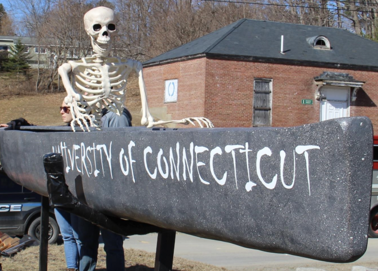 graveyacht canoe with skeleton sitting in it with a happy expression on its face